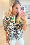 Leopard print top with green accent trim